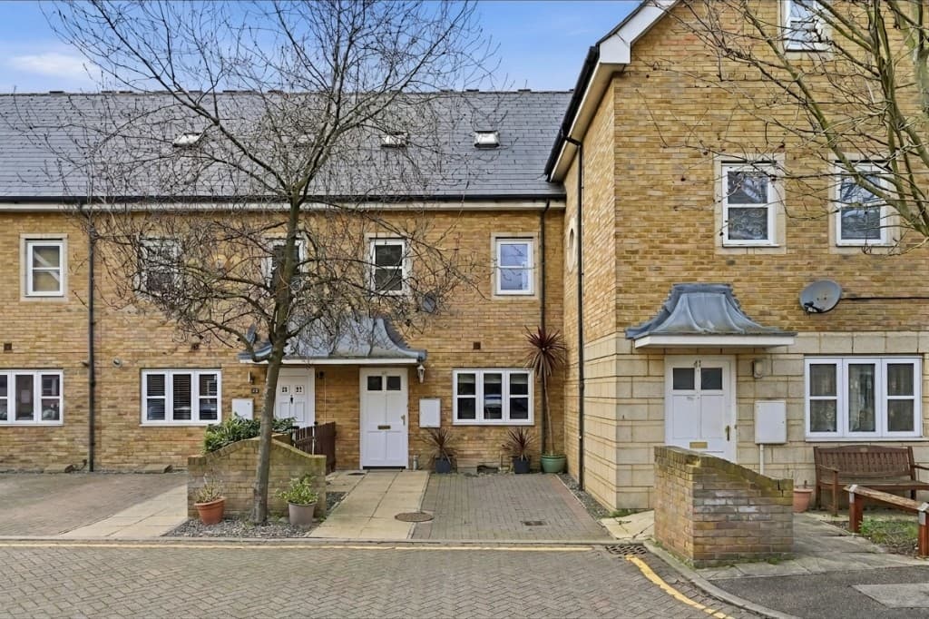 The same exterior with the bins, car and fridge removed by PhotoClear